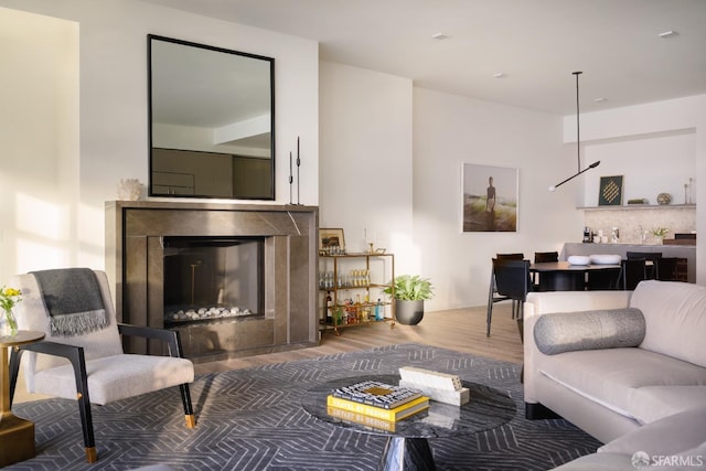 living area with a high end fireplace and wood finished floors