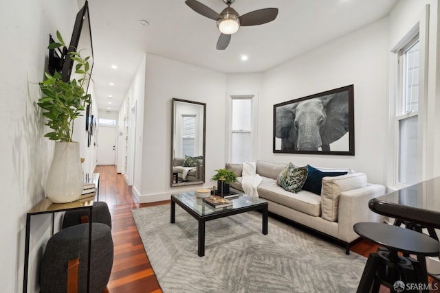 living room with baseboards, wood finished floors, a ceiling fan, and recessed lighting