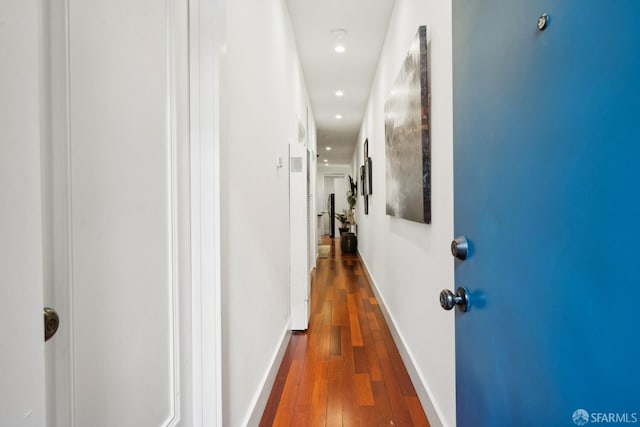 hallway featuring dark wood-style flooring, recessed lighting, and baseboards