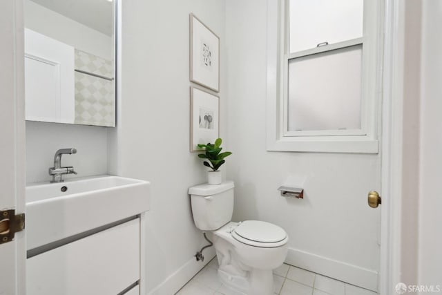 bathroom with tile patterned floors, vanity, toilet, and baseboards