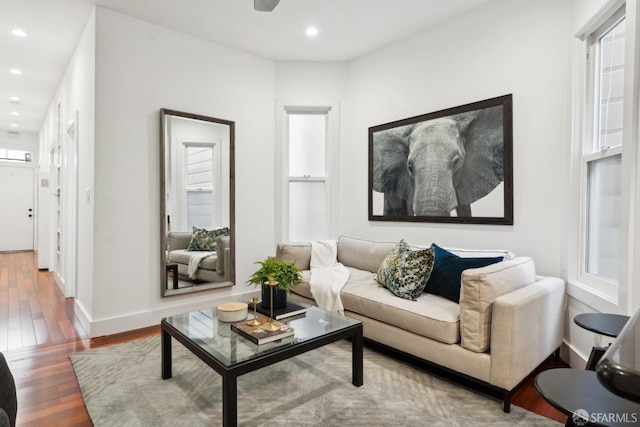 living room featuring a wealth of natural light, baseboards, hardwood / wood-style floors, and recessed lighting