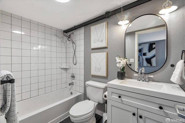 full bathroom with vanity, toilet, and tiled shower / bath