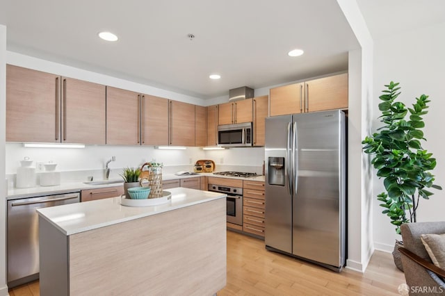 1160 Mission St Unit 2212, San Francisco, CA 94103 - kitchen with stainless steel appliances, light countertops, light wood-type flooring, recessed lighting, and a kitchen island