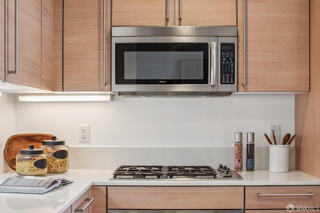 1160 Mission St Unit 2212, San Francisco, CA 94103 - kitchen view of stainless steel appliances, light countertops, and modern cabinets
