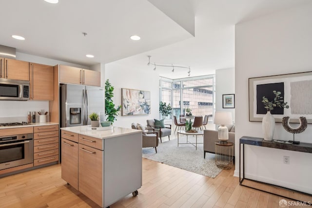 1160 Mission St Unit 2212, San Francisco, CA 94103 - kitchen with appliances with stainless steel finishes, light wood-type flooring, light countertops, rail lighting, and recessed lighting