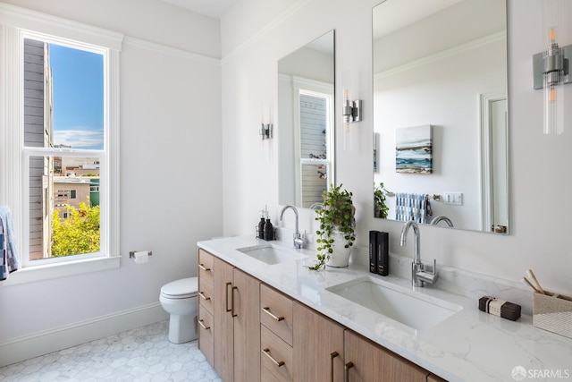 bathroom featuring vanity, tile patterned flooring, and toilet