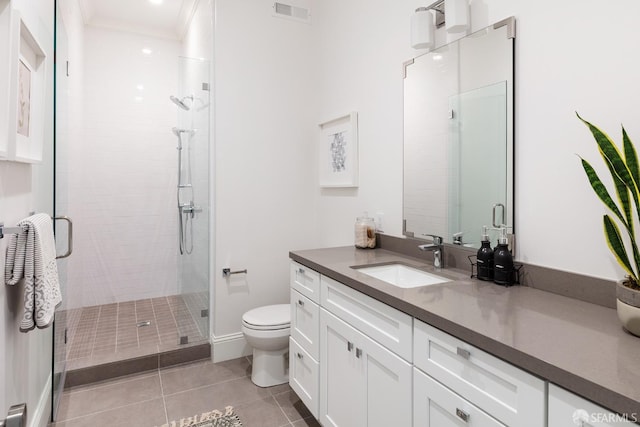 bathroom with vanity, crown molding, tile patterned flooring, toilet, and an enclosed shower