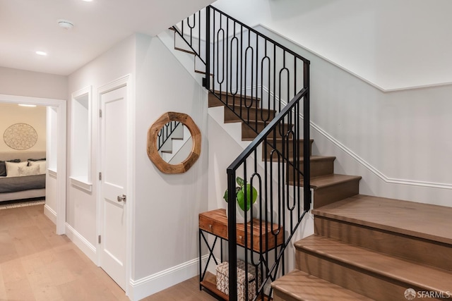 staircase featuring hardwood / wood-style floors