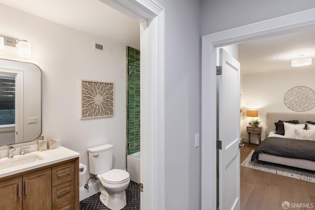 bathroom with vanity, toilet, and hardwood / wood-style flooring