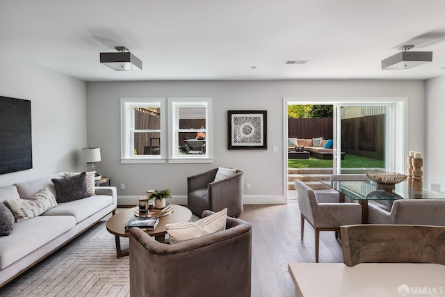 living room featuring light hardwood / wood-style flooring and a wealth of natural light