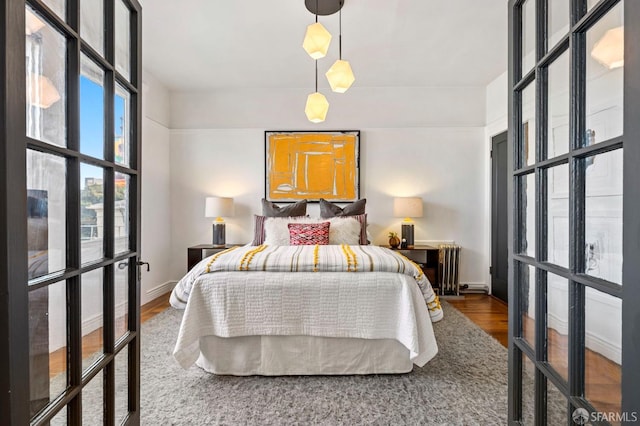 bedroom with wood finished floors and baseboards