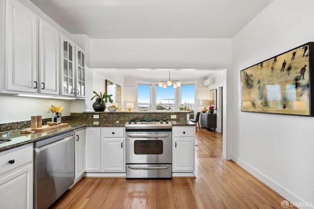 kitchen featuring a peninsula, white cabinetry, and appliances with stainless steel finishes