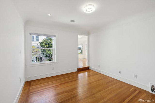 empty room featuring baseboards and wood finished floors