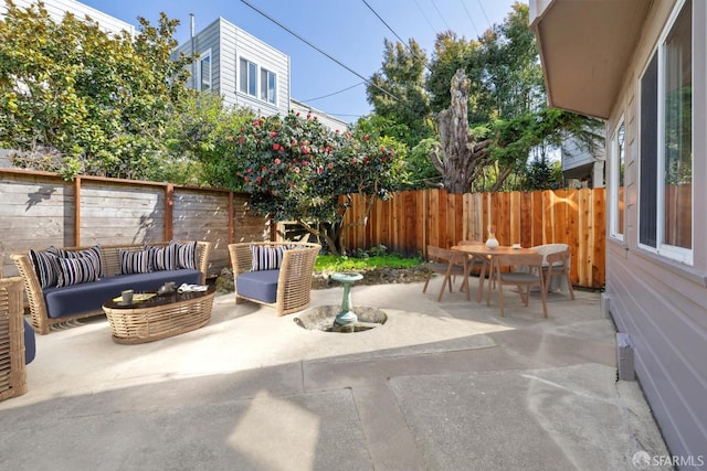 view of patio with outdoor dining space, a fenced backyard, and outdoor lounge area