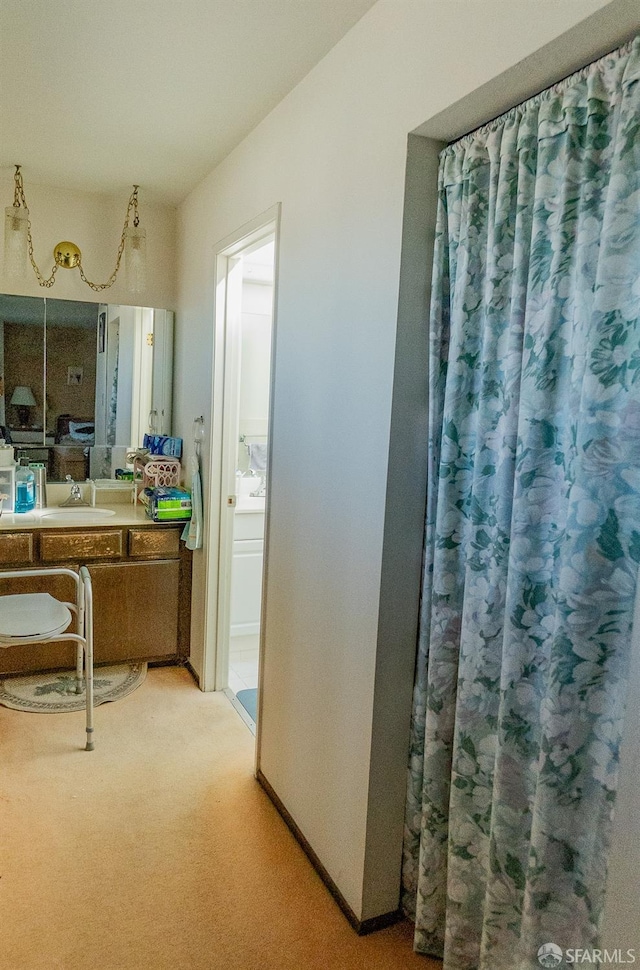 full bath with baseboards and vanity