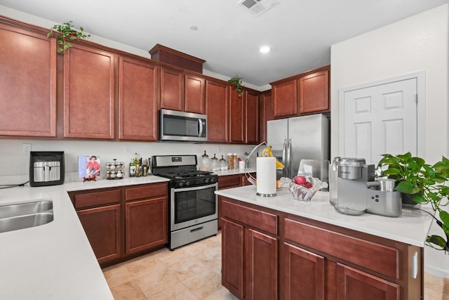 kitchen with visible vents, stainless steel appliances, light countertops, a sink, and recessed lighting