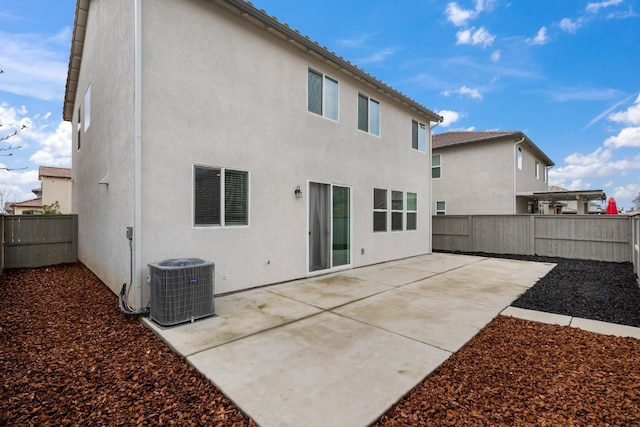 rear view of house featuring stucco siding, a patio area, a fenced backyard, and central air condition unit