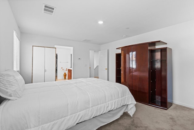 carpeted bedroom featuring visible vents and baseboards