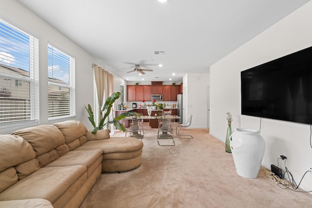 living room with light carpet, ceiling fan, visible vents, and recessed lighting
