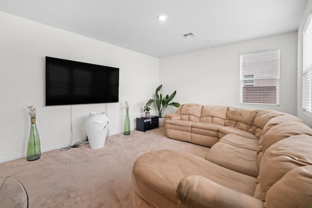 carpeted living area with recessed lighting, visible vents, and baseboards