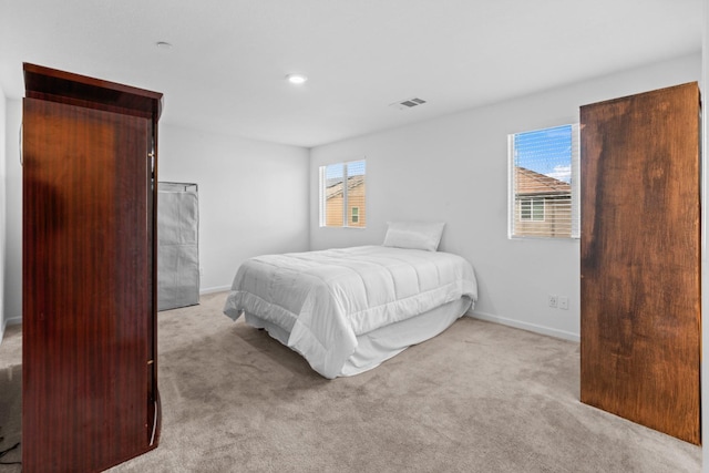 bedroom with carpet floors, baseboards, and visible vents