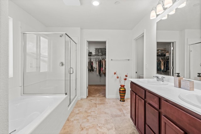 full bath with a garden tub, double vanity, a stall shower, and a sink