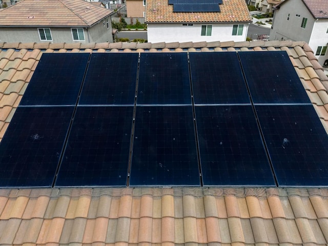 exterior space with a tile roof and a residential view
