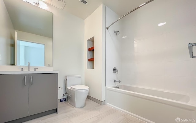 full bathroom featuring vanity, toilet, and tiled shower / bath