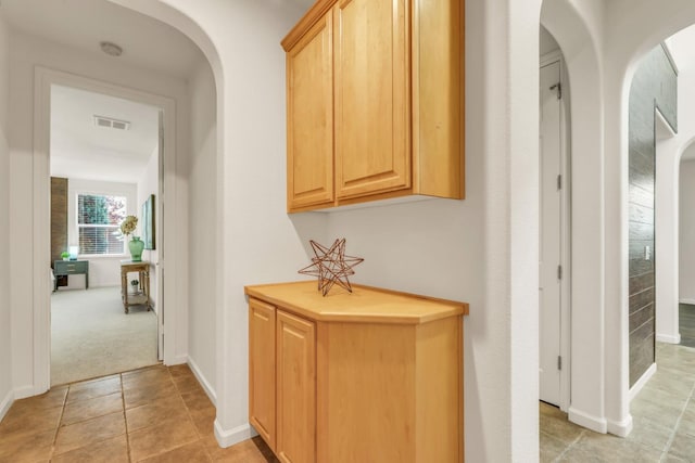 549 Fresian Dr, Oakdale, CA 95361 - hall with arched walkways, light tile patterned floors, baseboards, and light colored carpet