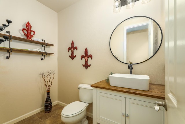 549 Fresian Dr, Oakdale, CA 95361 - bathroom with vanity, toilet, baseboards, and tile patterned flooring