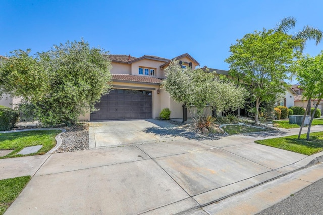 549 Fresian Dr, Oakdale, CA 95361 - view of front facade with driveway, stucco siding, a tiled roof, and a garage