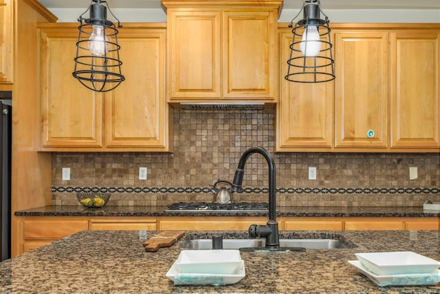 549 Fresian Dr, Oakdale, CA 95361 - kitchen with a sink, dark stone countertops, and backsplash