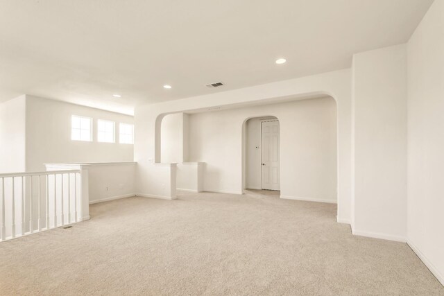549 Fresian Dr, Oakdale, CA 95361 - spare room featuring arched walkways, light carpet, recessed lighting, and baseboards