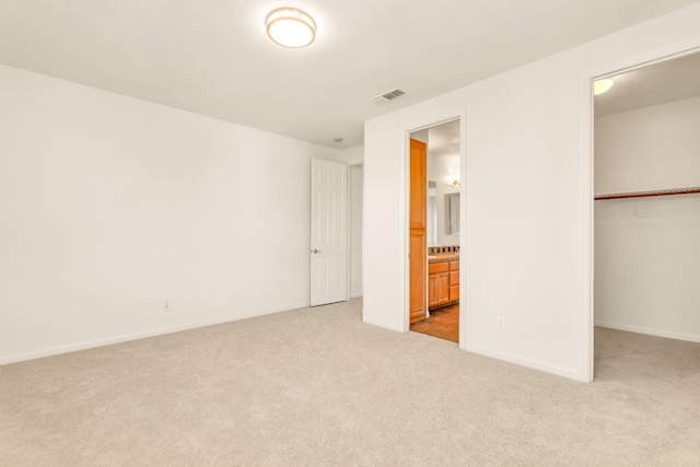 549 Fresian Dr, Oakdale, CA 95361 - unfurnished bedroom featuring carpet, a closet, a walk in closet, and baseboards