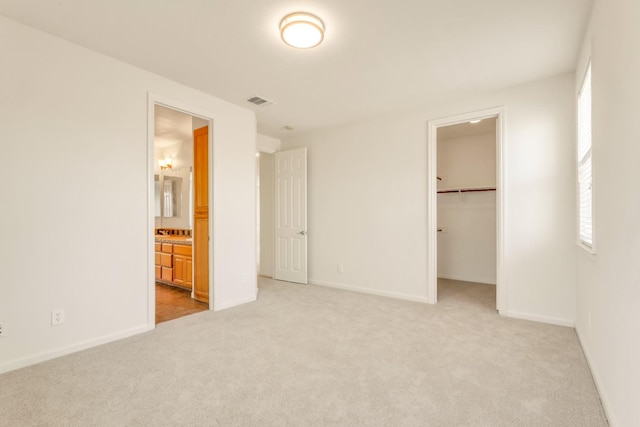 549 Fresian Dr, Oakdale, CA 95361 - unfurnished bedroom featuring carpet floors, a walk in closet, and baseboards