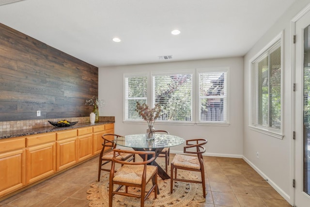 549 Fresian Dr, Oakdale, CA 95361 - dining room featuring light tile patterned floors, recessed lighting, baseboards, and wooden walls