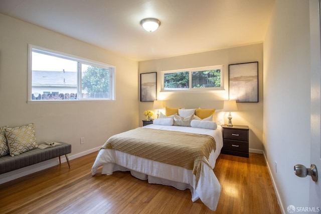 bedroom featuring wood finished floors and baseboards