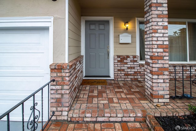 entrance to property with brick siding and stucco siding