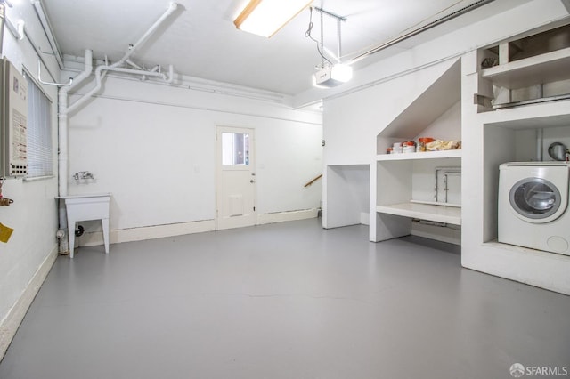 laundry room featuring laundry area, washer / clothes dryer, and a garage