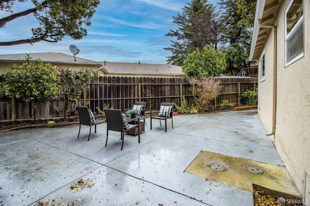 view of patio featuring fence