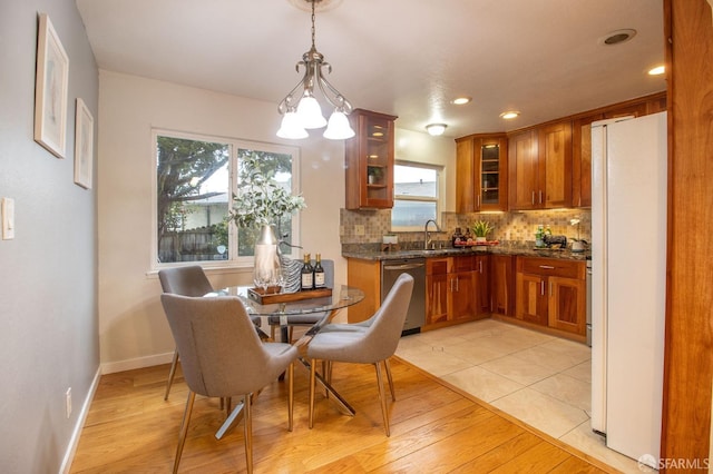 dining room featuring recessed lighting, a notable chandelier, baseboards, and light wood-style floors