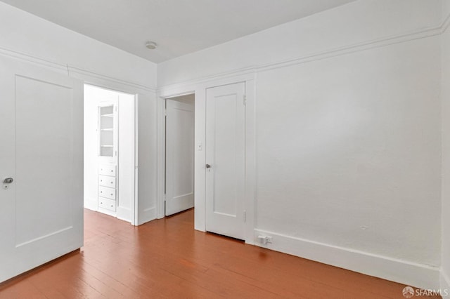 spare room featuring wood finished floors