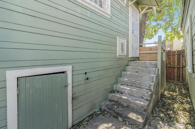 view of side of home featuring fence