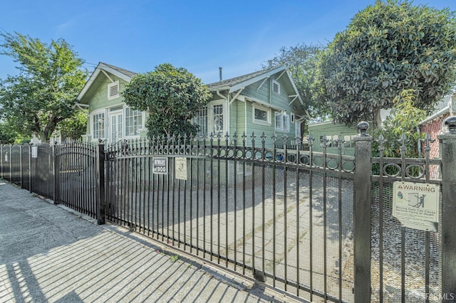 view of gate with a fenced front yard