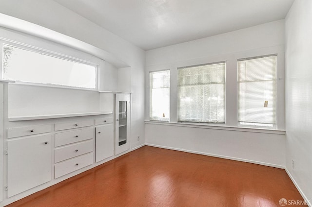 empty room with wood finished floors and baseboards
