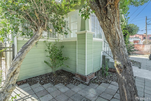 view of side of property featuring fence