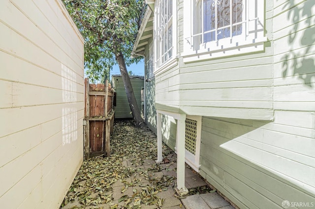 view of side of property featuring fence