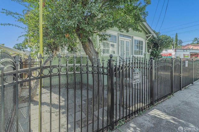 view of gate with a fenced front yard