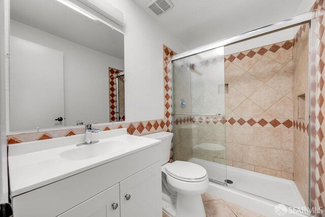 521 Ridgeview Ct, Pleasant Hill, CA 94523 - full bathroom featuring vanity, a shower stall, toilet, tile patterned flooring, and tile walls