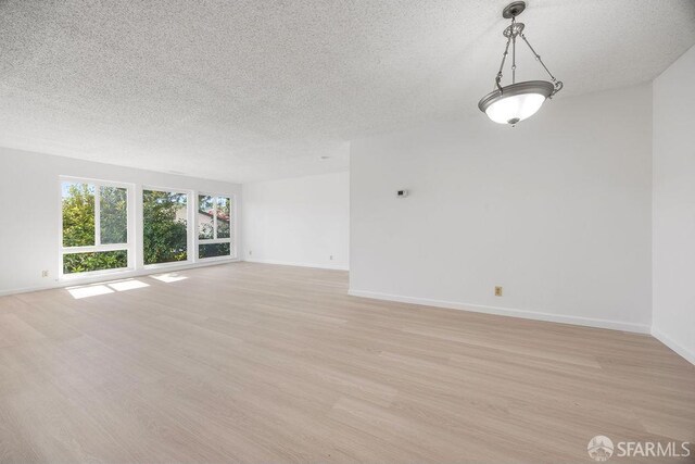 521 Ridgeview Ct, Pleasant Hill, CA 94523 - unfurnished room featuring a textured ceiling, light wood-style flooring, and baseboards